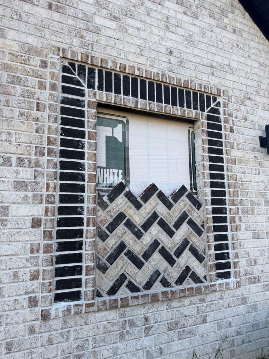 Close-up of decorative black-and-white brick pattern below a window