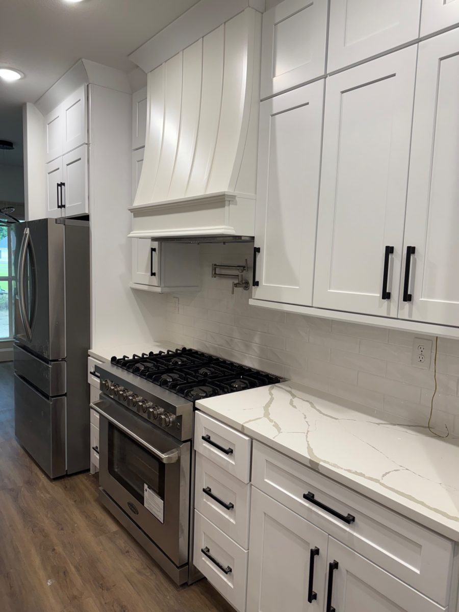 White kitchen cabinetry and marble-look counters