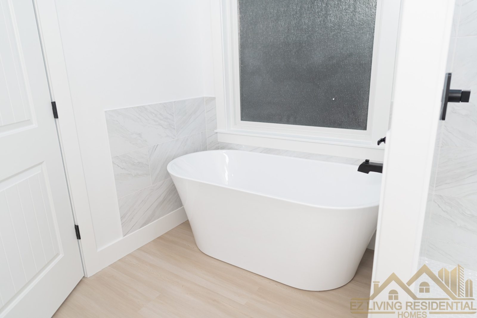 Bathroom with freestanding tub and tiled shower