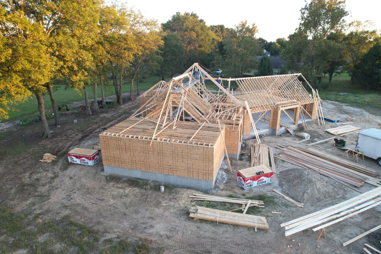 Custom home framing and roof trusses under construction at an EZ Living project
